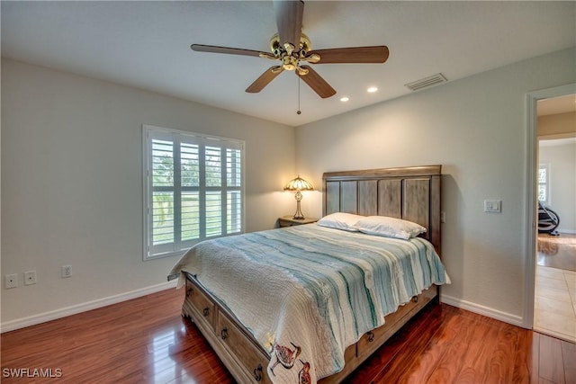 bedroom with recessed lighting, dark wood-style flooring, visible vents, and baseboards