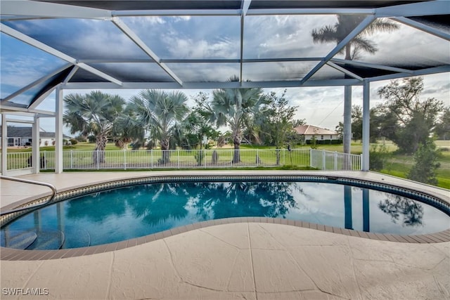 outdoor pool featuring a patio area, a lanai, and fence