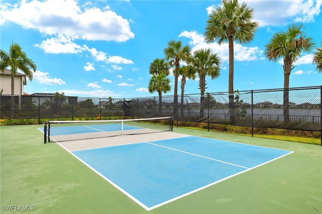 view of tennis court featuring basketball hoop