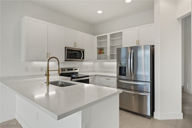 kitchen featuring kitchen peninsula, white cabinetry, and stainless steel appliances