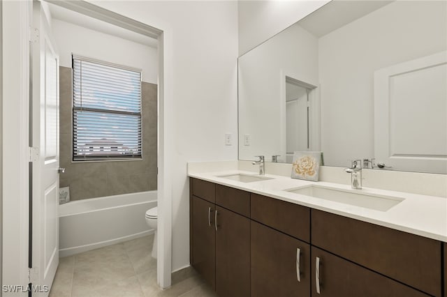 bathroom with tile patterned floors, vanity, a bathtub, and toilet