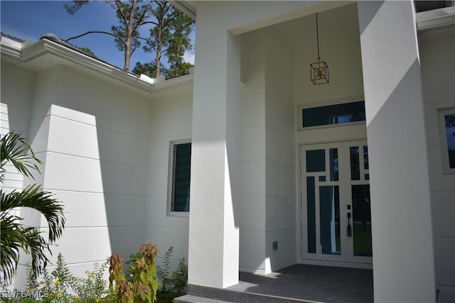 788 9th St SW, Naples, FL 34117 - view of exterior entry featuring stucco siding and french doors