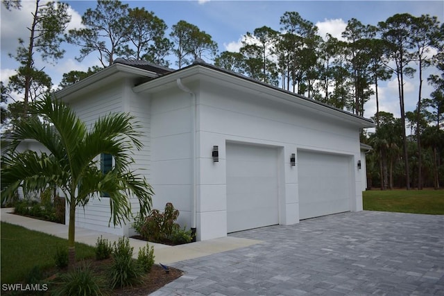 788 9th St SW, Naples, FL 34117 - view of property exterior featuring driveway and an attached garage