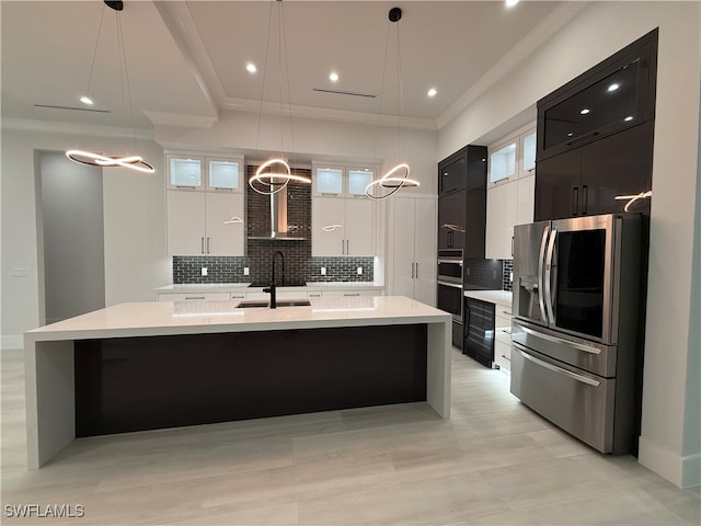 kitchen featuring decorative backsplash, appliances with stainless steel finishes, pendant lighting, and sink