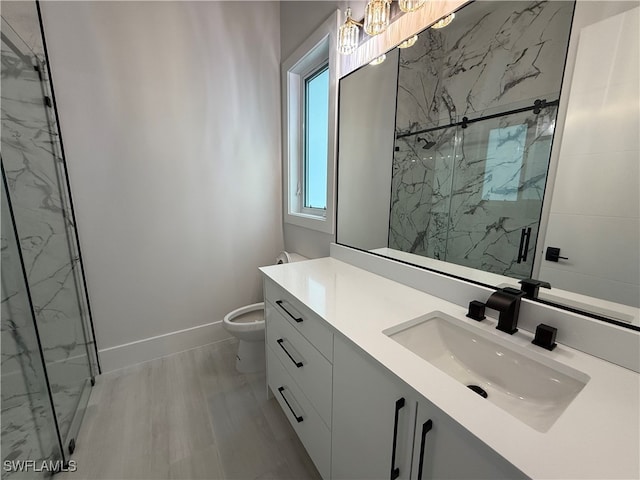 bathroom featuring a skylight, walk in shower, vanity, hardwood / wood-style flooring, and toilet