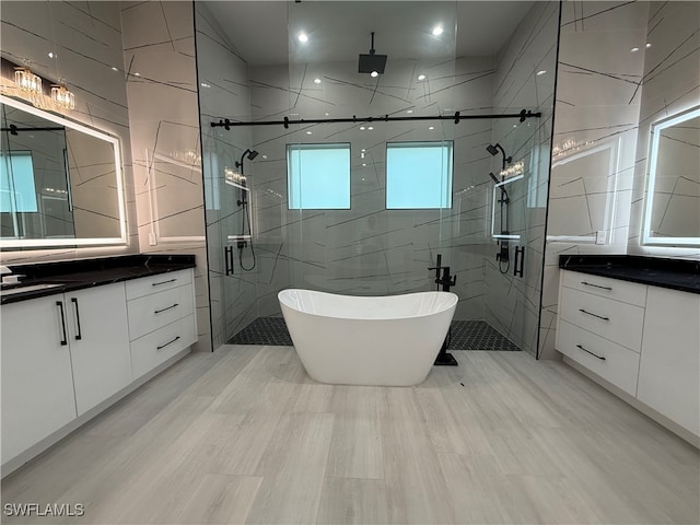 bathroom featuring vanity, tile walls, and shower with separate bathtub