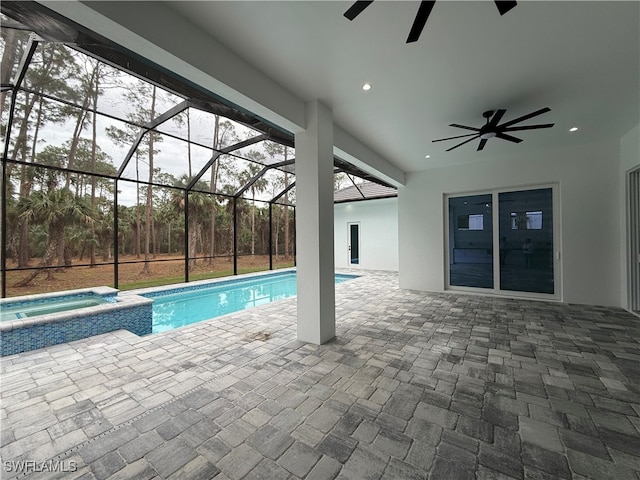 view of pool with ceiling fan, a lanai, an in ground hot tub, and a patio