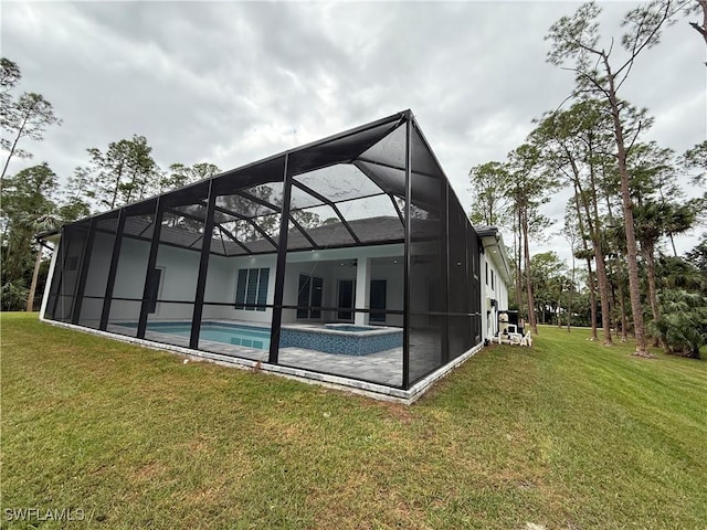 788 9th St SW, Naples, FL 34117 - rear view of house with a yard, a pool with connected hot tub, glass enclosure, and a patio