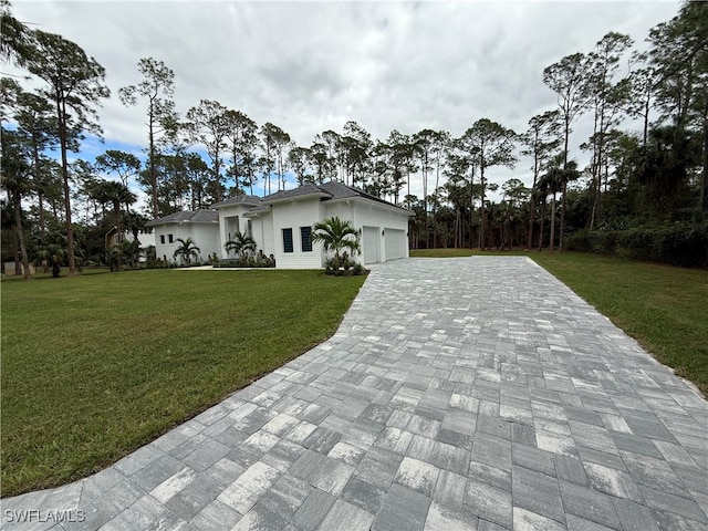 view of front of house with a front yard and a garage