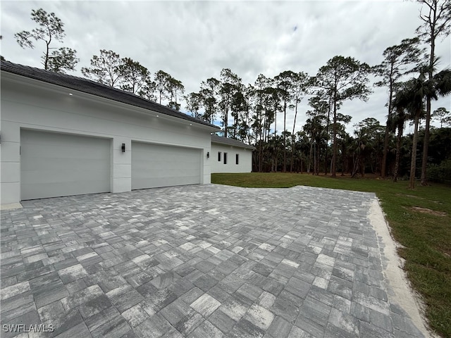 exterior space with a garage and a yard