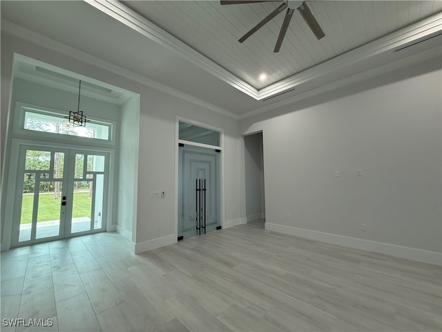 spare room with french doors, a raised ceiling, ceiling fan, ornamental molding, and light hardwood / wood-style floors