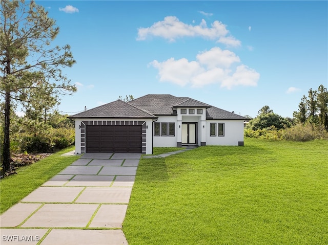 prairie-style home featuring a garage and a front yard