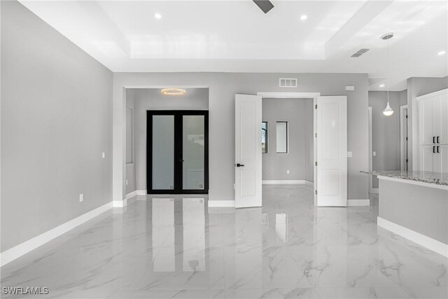 1220 Edison Ave, Lehigh Acres, FL 33972 - empty room featuring a tray ceiling, visible vents, baseboards, and marble finish floor