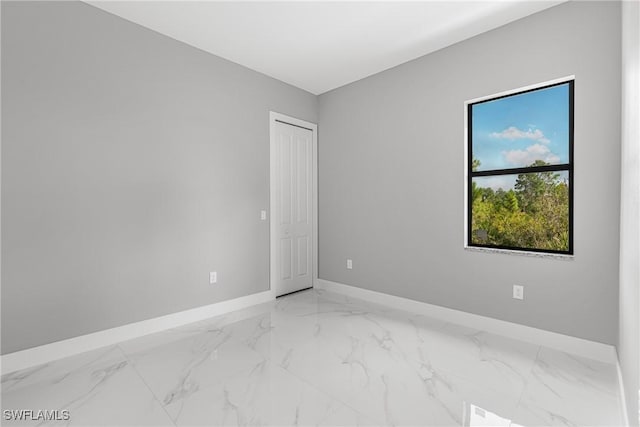 1220 Edison Ave, Lehigh Acres, FL 33972 - empty room with baseboards and marble finish floor