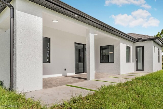 1220 Edison Ave, Lehigh Acres, FL 33972 - rear view of house featuring a patio area and stucco siding