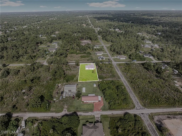1220 Edison Ave, Lehigh Acres, FL 33972 - birds eye view of property featuring a view of trees