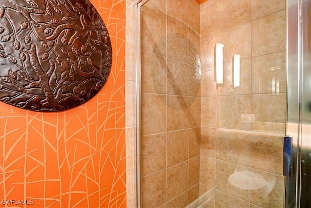 bathroom with a tile shower