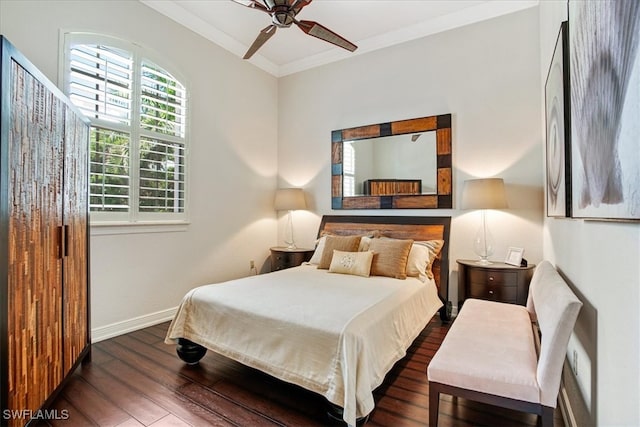 bedroom with ornamental molding, dark hardwood / wood-style floors, and ceiling fan