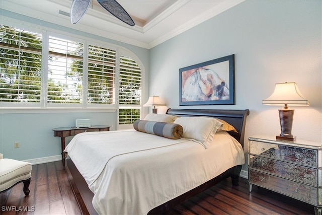 bedroom featuring ceiling fan, dark hardwood / wood-style flooring, ornamental molding, and a raised ceiling