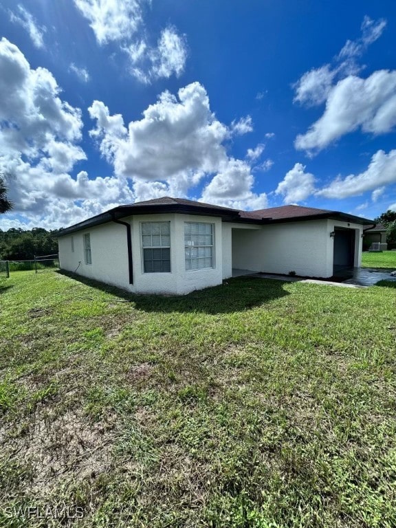 view of property exterior with a lawn