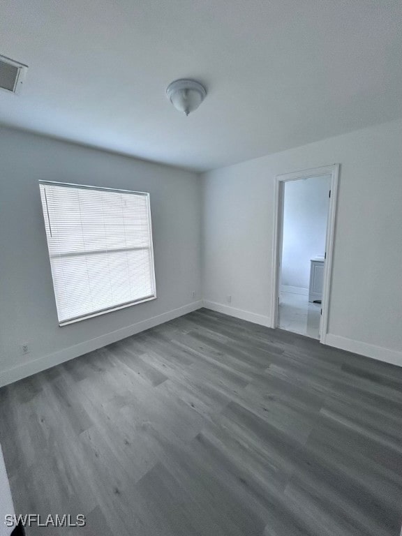 spare room featuring wood-type flooring