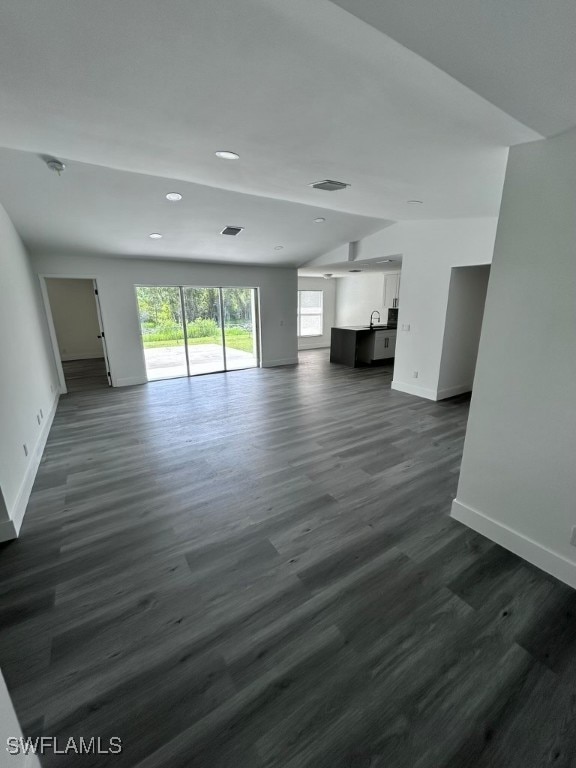 unfurnished living room featuring dark hardwood / wood-style floors