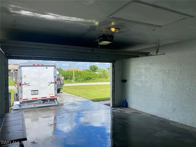 garage featuring a garage door opener and a carport