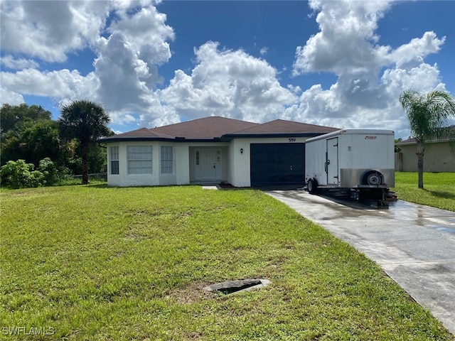 view of front of property featuring a garage and a front lawn