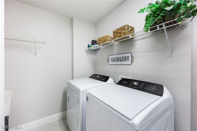 washroom with independent washer and dryer and light tile patterned floors