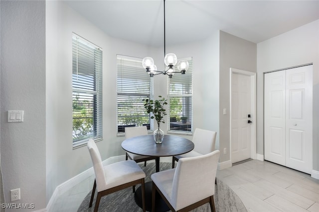 dining space with a notable chandelier and light tile patterned floors