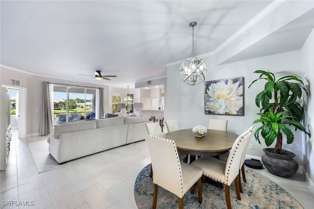 dining area with light tile patterned floors, ceiling fan with notable chandelier, and ornamental molding