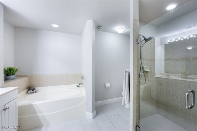 bathroom with independent shower and bath, vanity, and tile patterned flooring