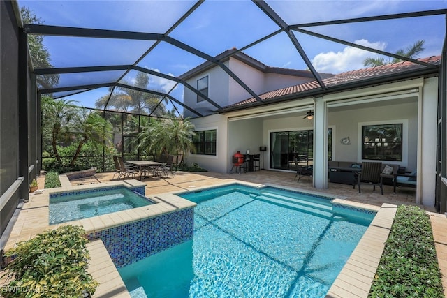 view of swimming pool featuring ceiling fan, glass enclosure, an in ground hot tub, and a patio area