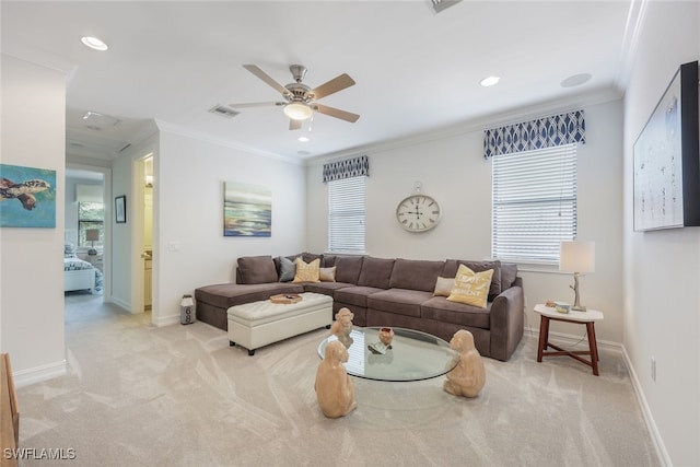 living room featuring ceiling fan, light colored carpet, and crown molding