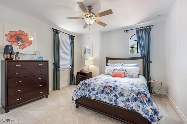 bedroom with ceiling fan and light colored carpet