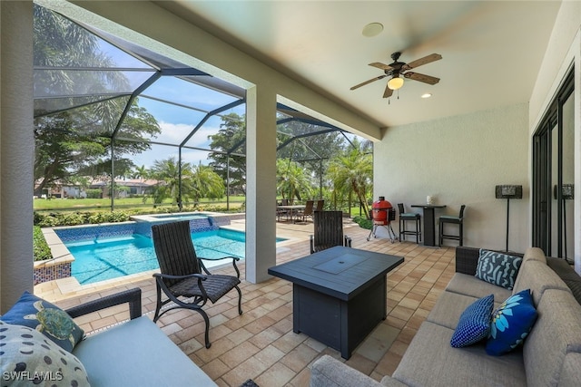 view of patio featuring ceiling fan, an outdoor living space, and a lanai