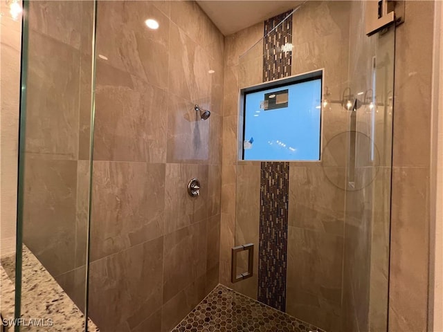 full bath with a tile shower