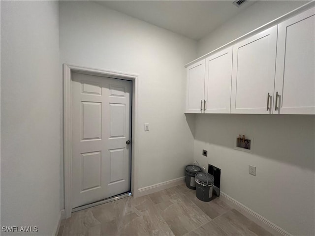 laundry area with cabinet space, electric dryer hookup, baseboards, and washer hookup