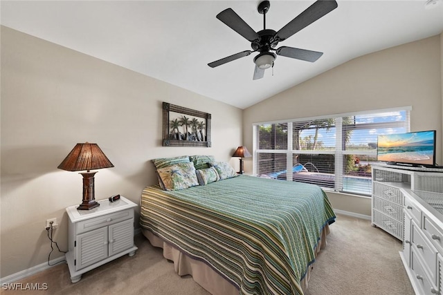 carpeted bedroom with ceiling fan and vaulted ceiling