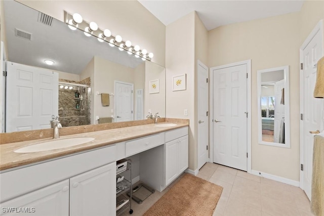 bathroom with tile patterned flooring, vanity, and an enclosed shower