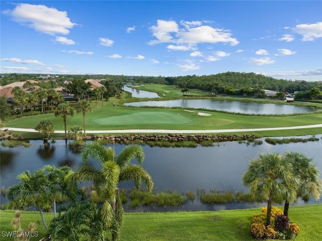 view of home's community with a water view, a lawn, and view of golf course