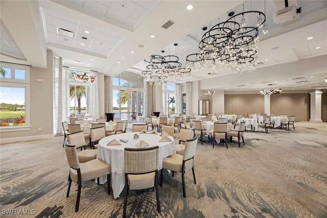 dining room featuring a towering ceiling and a tray ceiling