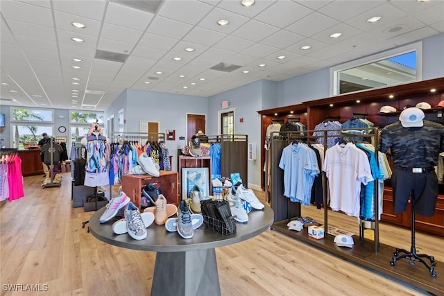 interior space with a drop ceiling and light hardwood / wood-style flooring