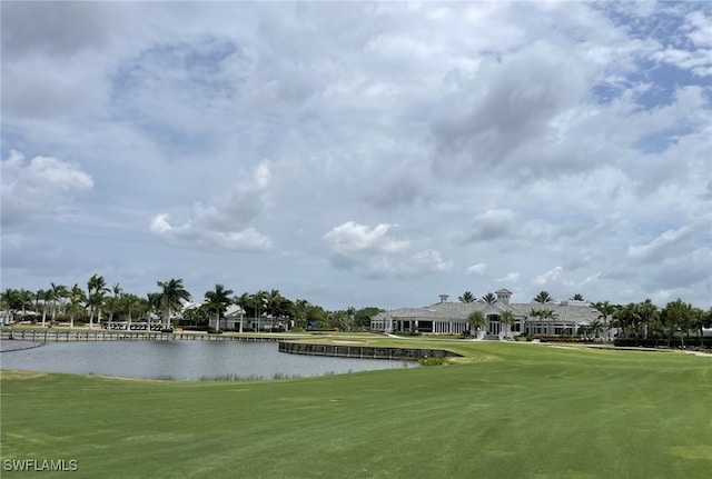 view of home's community featuring a water view and a lawn