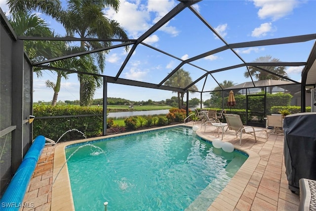 view of pool with area for grilling, pool water feature, glass enclosure, a water view, and a patio area