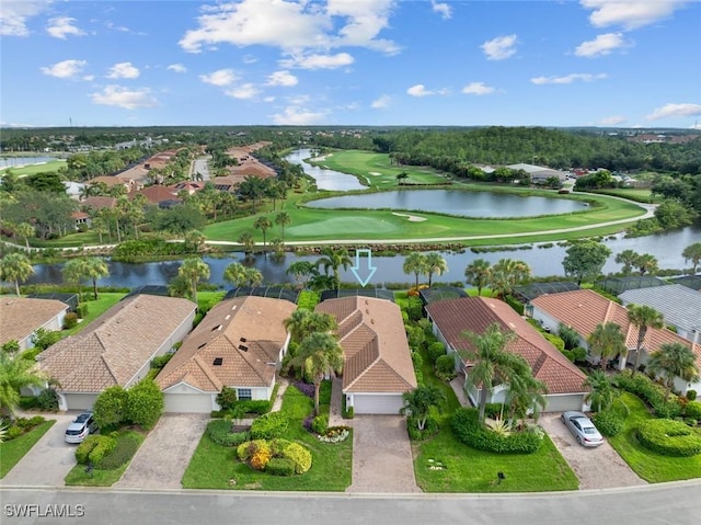 drone / aerial view with a residential view, golf course view, and a water view