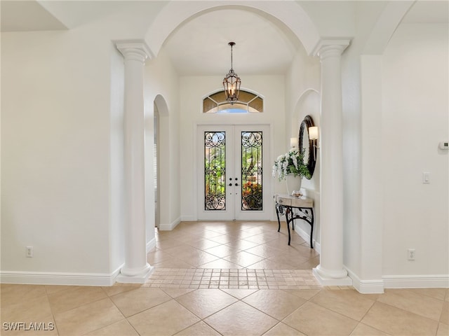 foyer with light tile patterned flooring and french doors