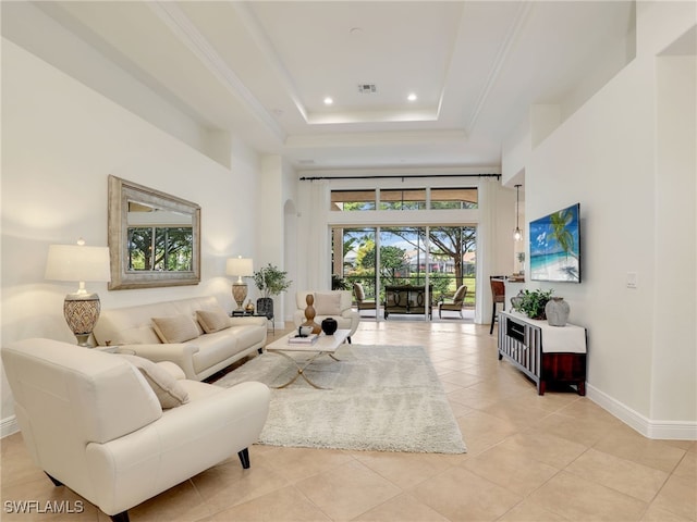 living room featuring light tile patterned floors and a tray ceiling