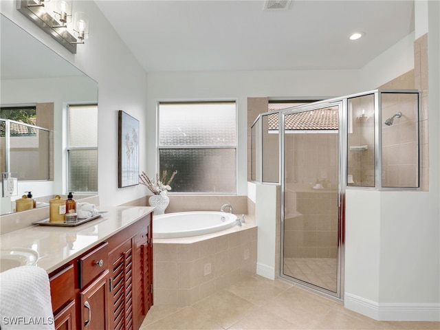 bathroom featuring tile patterned flooring, vanity, and shower with separate bathtub