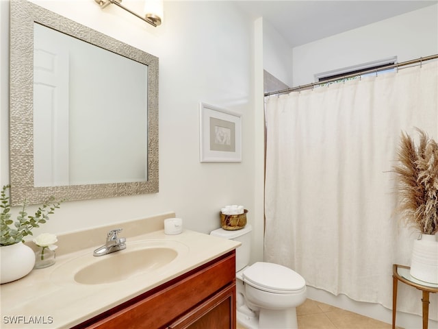 bathroom featuring tile patterned floors, vanity, toilet, and walk in shower